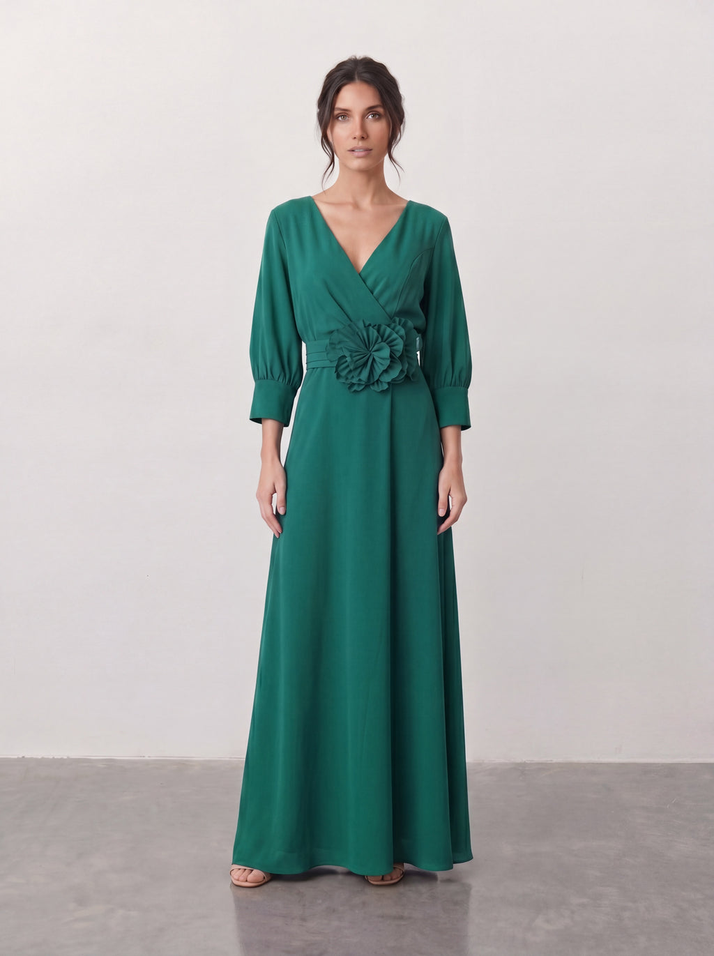 Elegancka sukienka maxi w butelkowej zieleni z kopertowym dekoltem V, rękawami balonowymi i kwiatem z tkaniny przy talii
